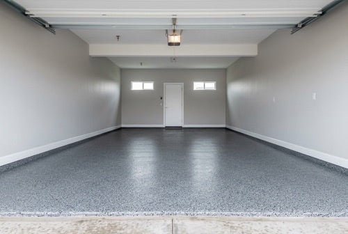 Light gray decorative flake epoxy floor in a finished two-car residential garage